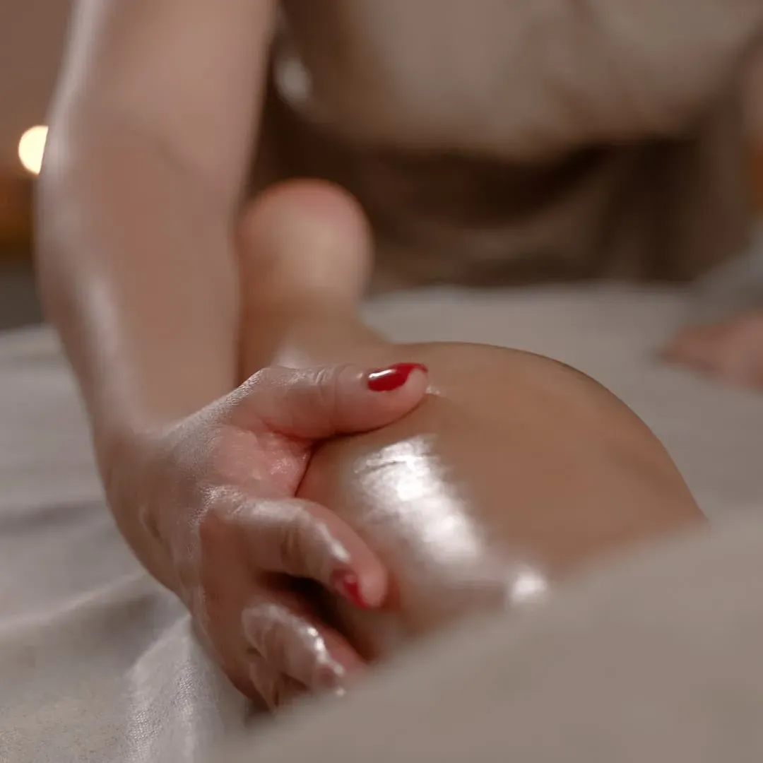 Oil massage along the forearm and upper arm
